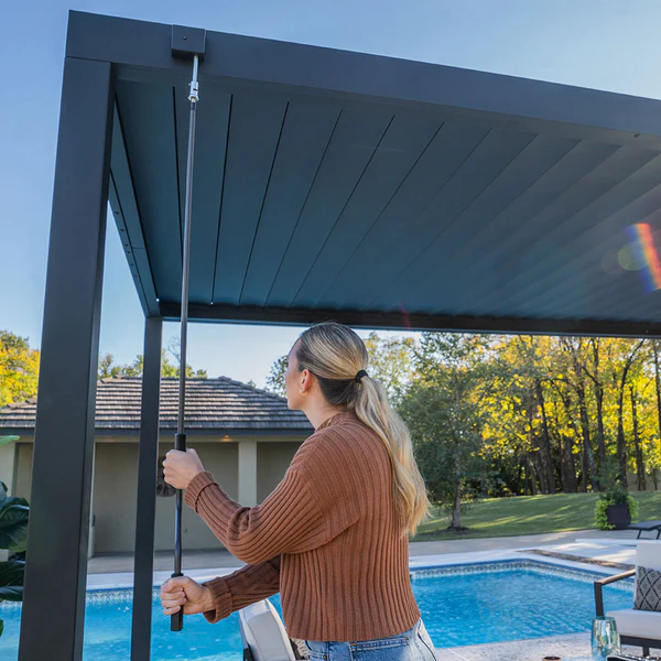 The louvers open fully to allow sunlight through or close fully for complete shade and rain protection.