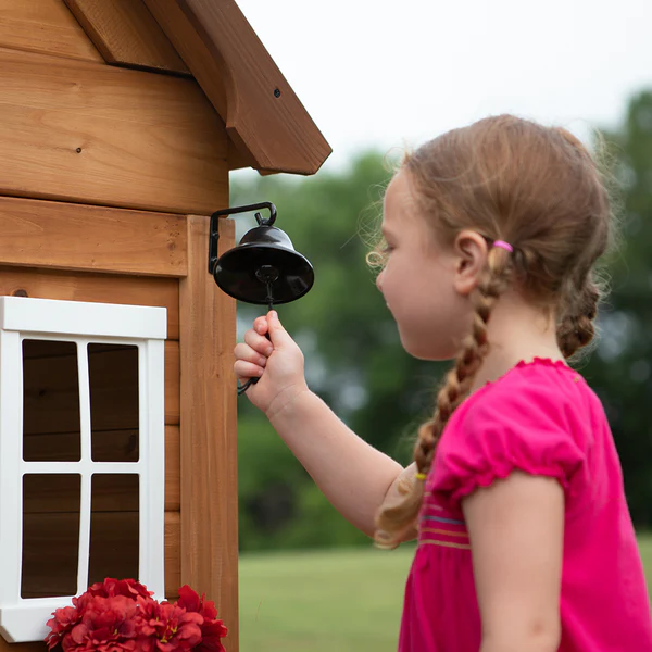 An indoor kitchen with a sink, stove, and cordless phone provide hours of imaginative play.
