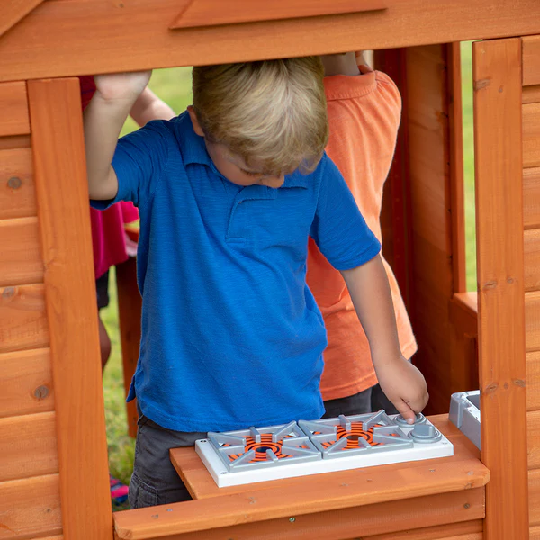 An indoor kitchen with a sink, stove, and cordless phone provide hours of imaginative play.